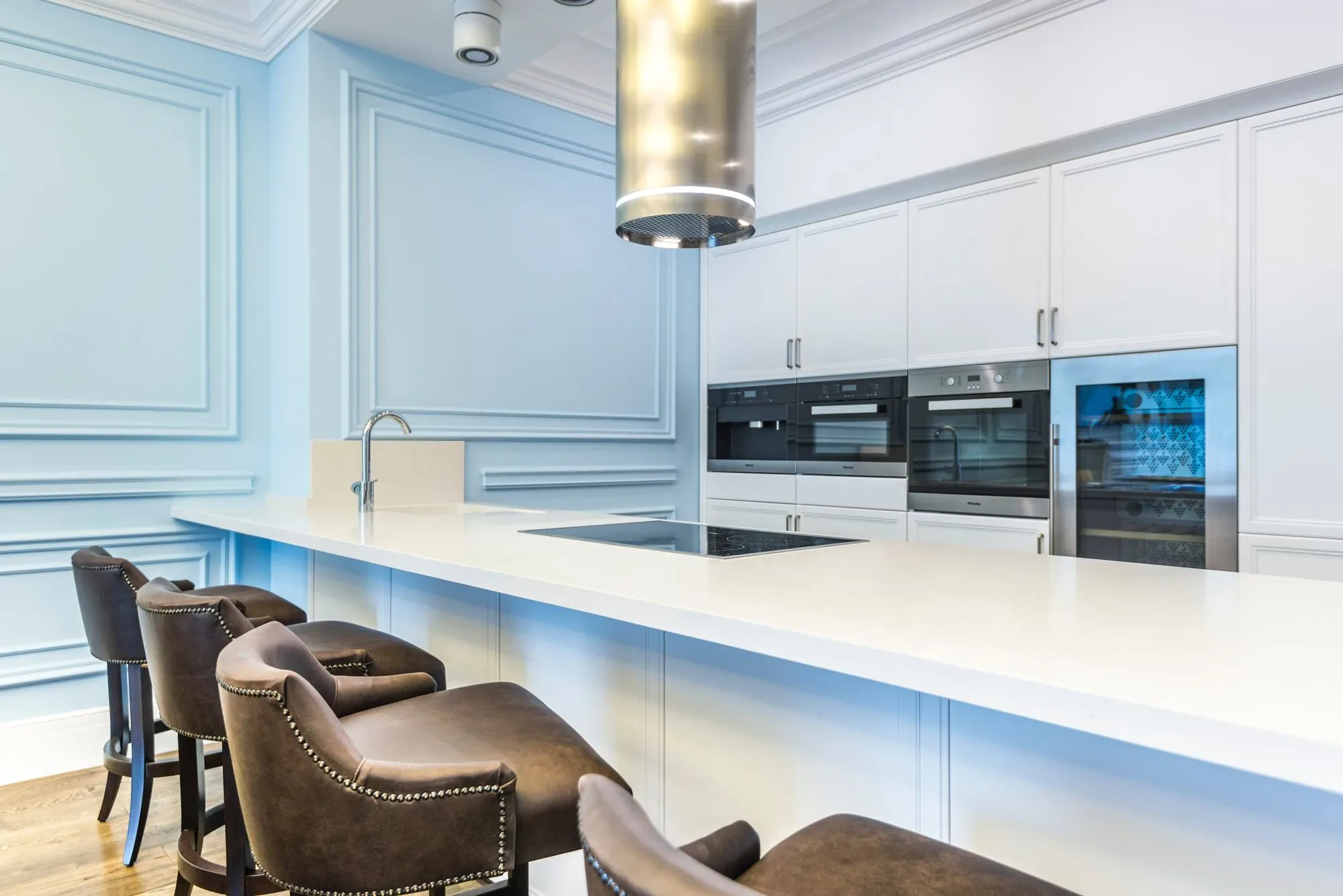 A set of cabinets and countertop painted bright white